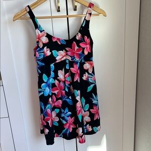 Vibrant floral one piece swim suit with dress like silhouette.